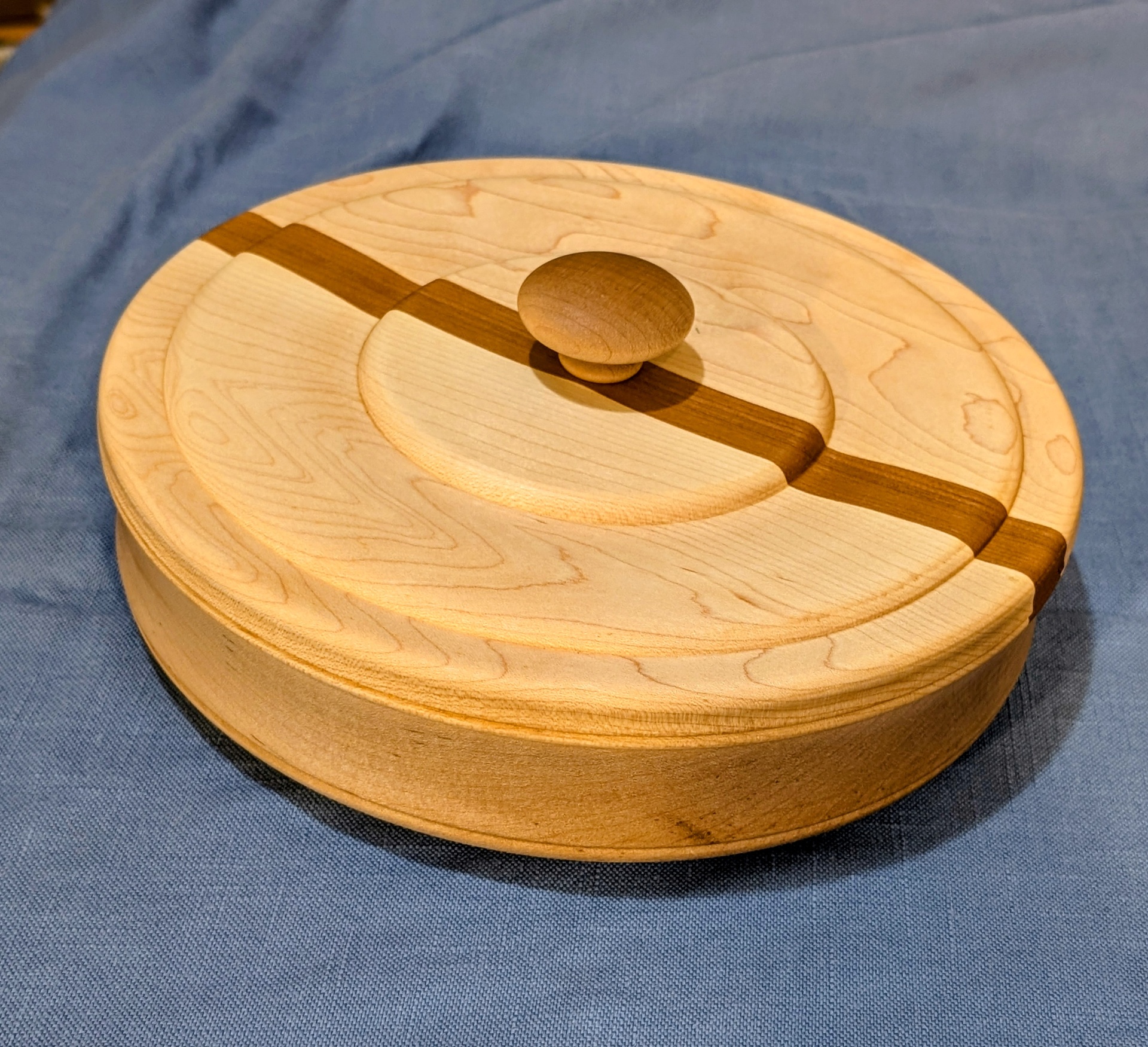 Maple jewelry box with a cherry stripe running across the lid